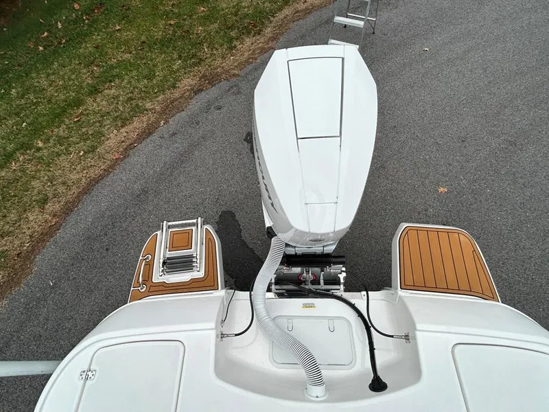 Slide: The Image of 2025 Caymas 26 HB boat with outboard motor and teak deck accents. - 36