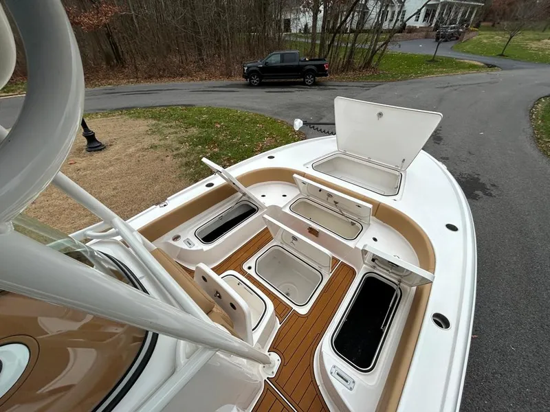 Slide: The Image of 2025 Caymas 26 HB boat with open storage compartments on deck. - 42