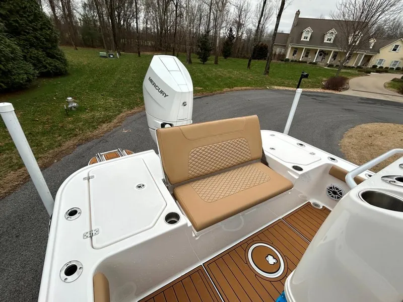 Slide: The Image of 2025 Caymas 26 HB boat with tan seating and Mercury outboard motor. - 47