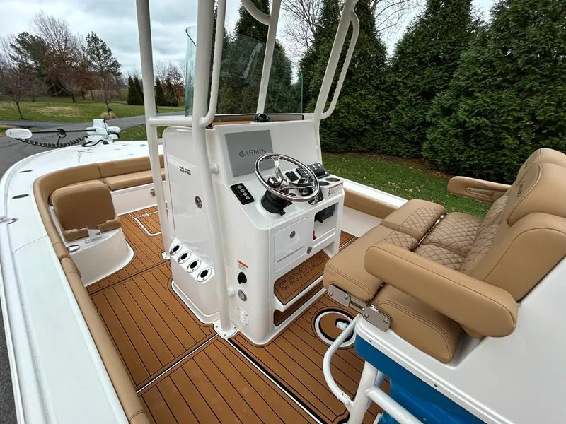 Slide: The Image of 2025 Caymas 26 HB boat interior with tan seating and modern helm controls. - 48