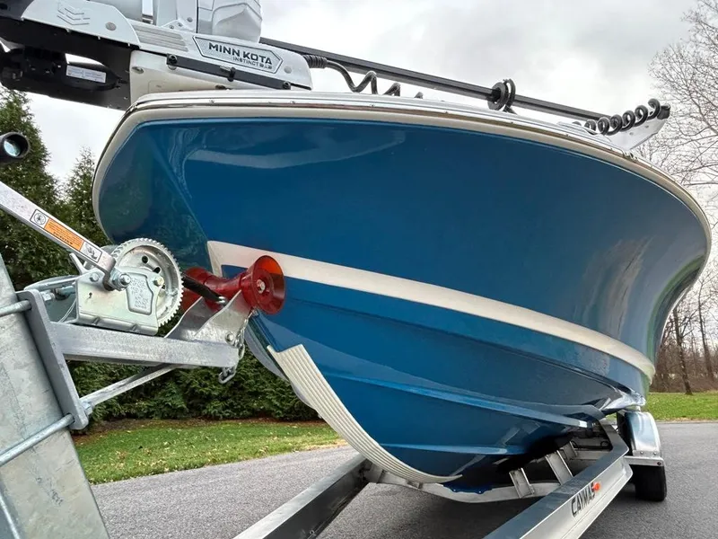 Slide: The Image of 2025 Caymas 26 HB boat on trailer, featuring a blue hull and Minn Kota trolling motor. - 9