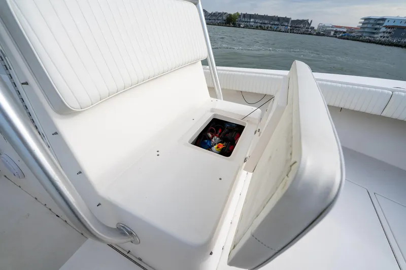 Slide: The Image of 2003 Regulator 32 Center Console boat with open storage compartment on deck. - 10