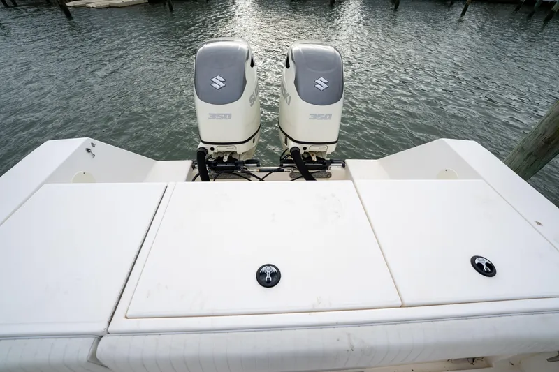 Slide: The Image of 2003 Regulator 32 Center Console with twin Suzuki 350 outboard engines on water. - 17