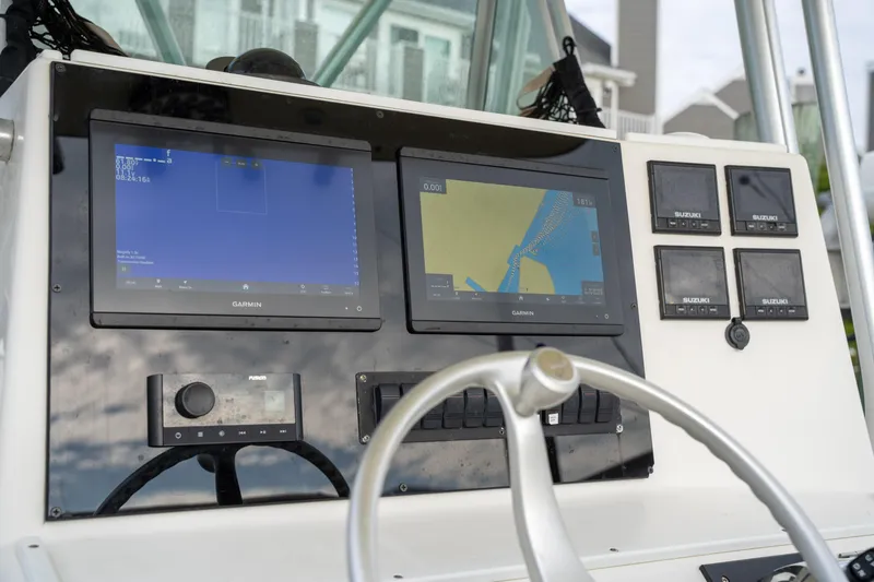 Slide: The Image of 2003 Regulator 32 Center Console dashboard with navigation screens and controls. - 18
