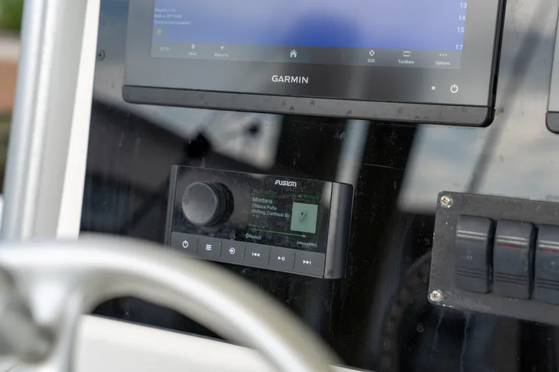 Slide: The Image of Console of 2003 Regulator 32 Center Console with Garmin and Fusion audio system. - 19