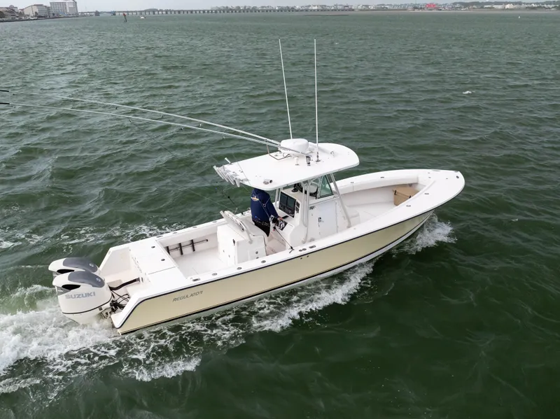 Slide: The Image of 2003 Regulator 32 Center Console boat cruising on open water. - 5