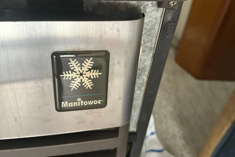 Slide: The Image of Manitowoc ice machine logo on stainless steel surface, 2011 Blue Fin 33 CC. - 16