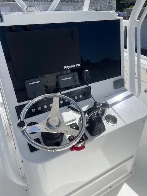 Slide: The Image of 2019 Buddy Davis CC boat helm with Raymarine electronics and steering wheel. - 2
