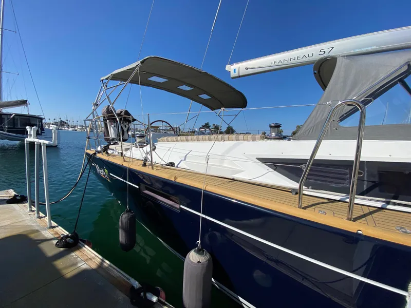 Slide: The Image of 2013 Jeanneau 57 yacht docked at marina, side view. - 13