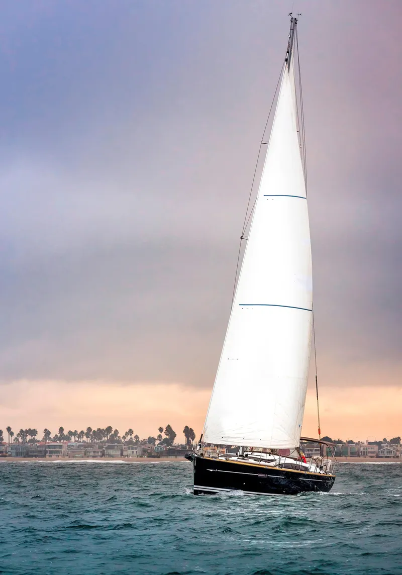Slide: The Image of Sailing yacht Jeanneau 57, 2013 model, gliding on ocean at sunset. - 2