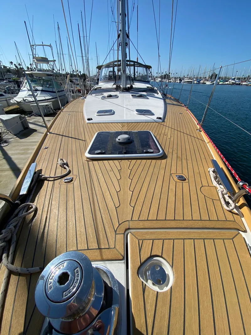 Slide: The Image of 2013 Jeanneau 57 sailboat with teak deck, docked in marina. - 26