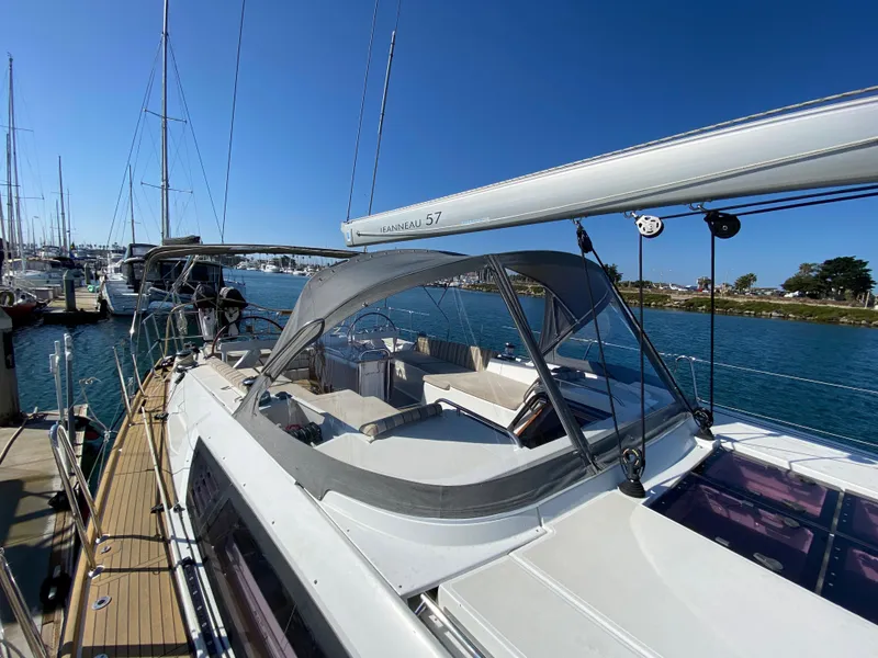 Slide: The Image of 2013 Jeanneau 57 sailboat docked in marina under clear blue sky. - 31