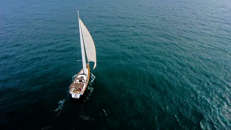 Slide: The Image of Aerial view of 2013 Jeanneau 57 sailboat navigating open sea. - 4