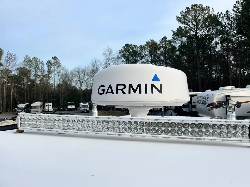 Slide: The Image of Garmin radar on 2019 Sportsman Open 252 Center Console boat, surrounded by trees and RVs. - 18