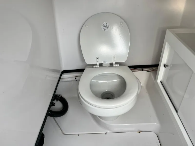 Slide: The Image of 2019 Sportsman Open 252 Center Console boat toilet interior. - 19