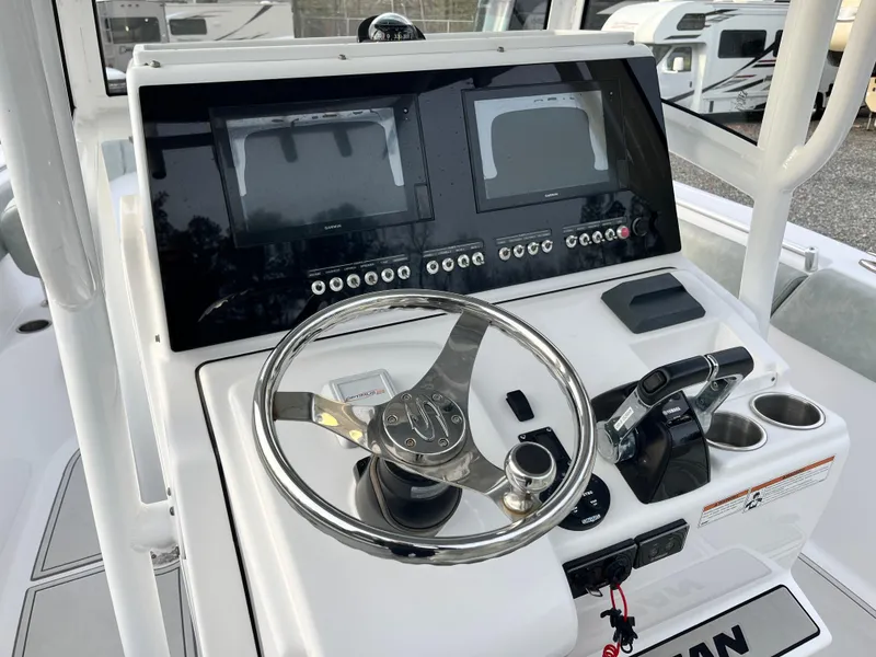 Slide: The Image of 2019 Sportsman Open 252 Center Console dashboard with dual displays and steering wheel. - 20