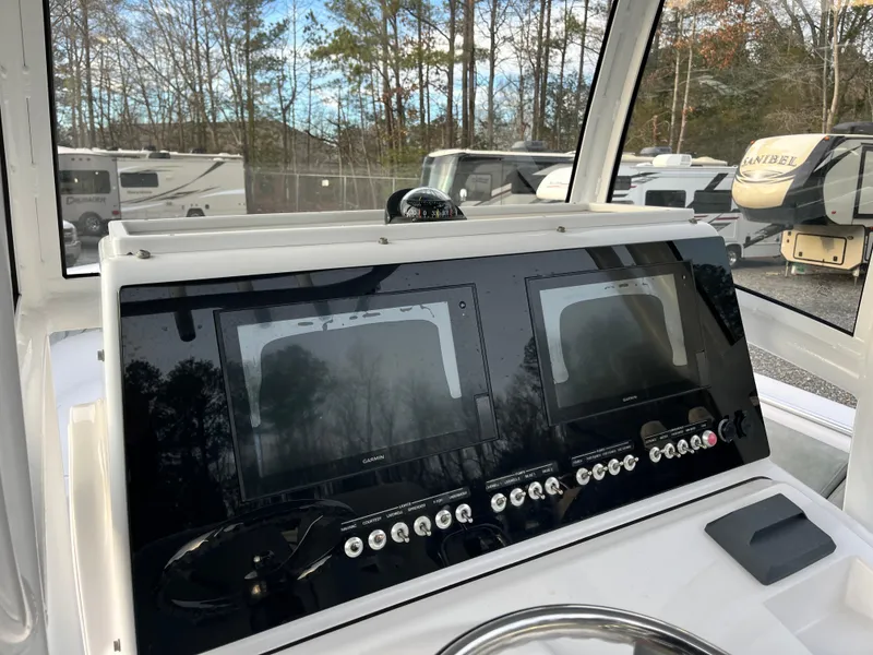 Slide: The Image of 2019 Sportsman Open 252 Center Console dashboard with dual screens and controls. - 21