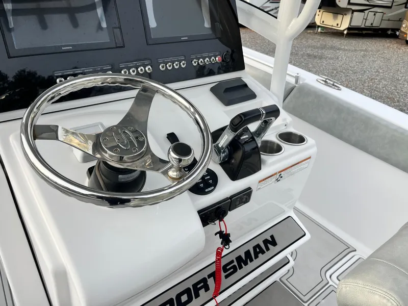 Slide: The Image of 2019 Sportsman Open 252 Center Console boat dashboard with steering wheel and controls. - 24
