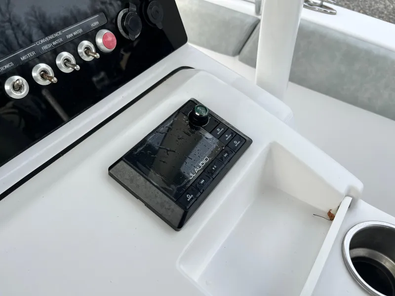 Slide: The Image of 2019 Sportsman Open 252 Center Console dashboard with controls and cup holder. - 26