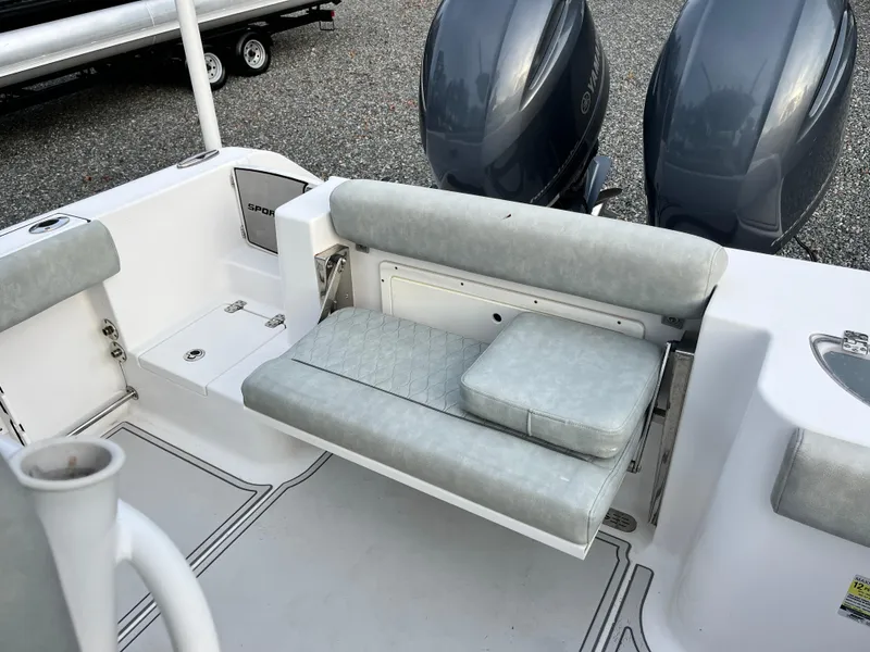 Slide: The Image of 2019 Sportsman Open 252 Center Console boat with cushioned seating and dual outboard motors. - 28