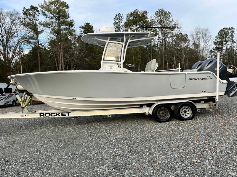 Slide: The Image of 2019 Sportsman Open 252 Center Console boat on trailer, parked outdoors. - 31