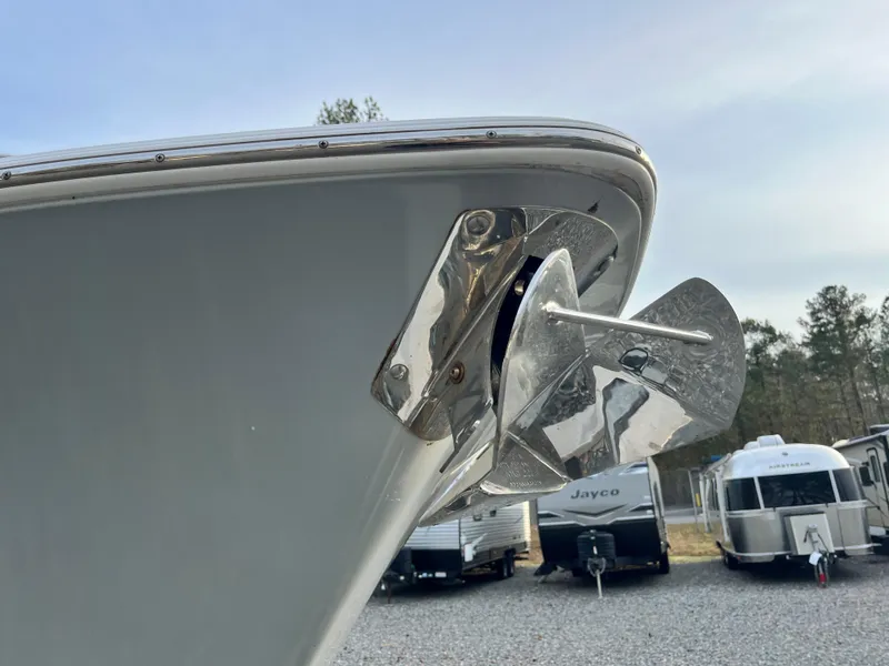 Slide: The Image of 2019 Sportsman Open 252 Center Console boat with anchor, parked near RVs. - 5