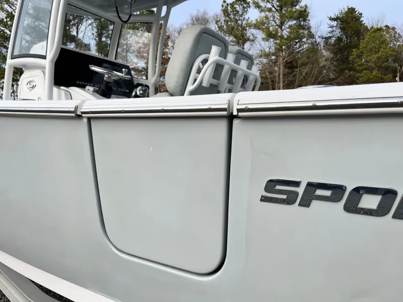 Slide: The Image of 2019 Sportsman Open 252 Center Console boat, side view with logo, in a wooded area. - 9