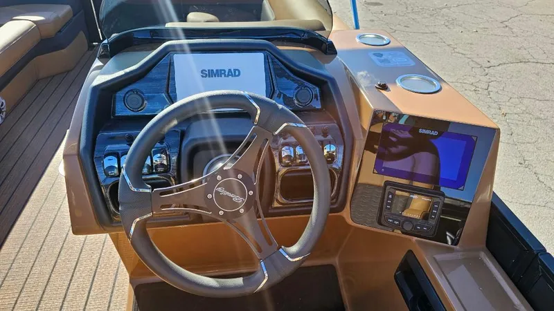 Slide: The Image of 2025 Bentley Pontoons Elite 253 Swingback dashboard with steering wheel and navigation system. - 3