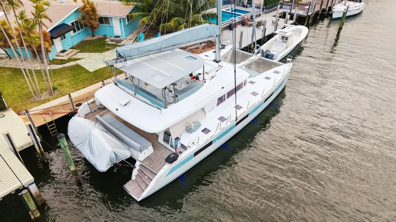 Slide: The Image of Lagoon 620 catamaran docked at a marina, 2014 model, aerial view. - 11
