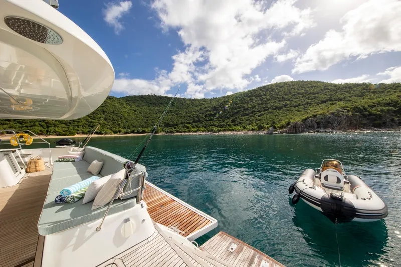 Slide: The Image of Lagoon 620 yacht, 2014 model, anchored in serene bay with lush green hills. - 122