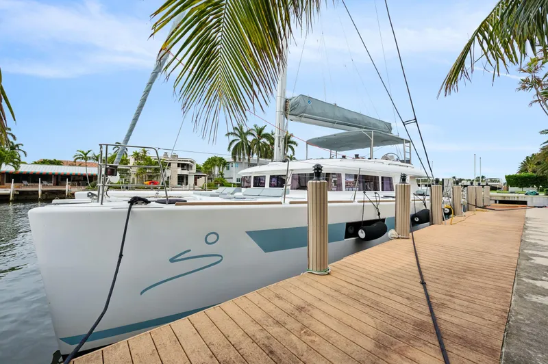 Slide: The Image of Lagoon 620 catamaran docked by palm trees, 2014 model, sunny day. - 18