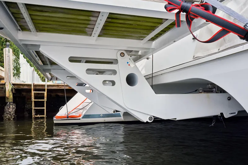 Slide: The Image of Underneath view of a 2014 Lagoon 620 catamaran docked by the water. - 29