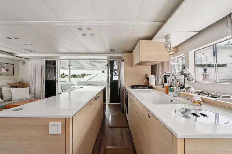 Slide: The Image of Interior of 2014 Lagoon 620 yacht, featuring modern kitchen and spacious design. - 42