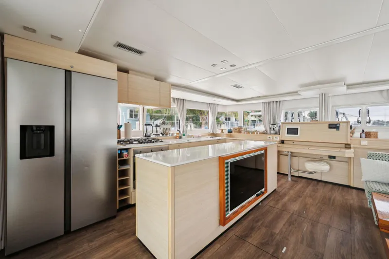 Slide: The Image of Spacious interior of 2014 Lagoon 620 yacht with modern kitchen and large windows. - 44