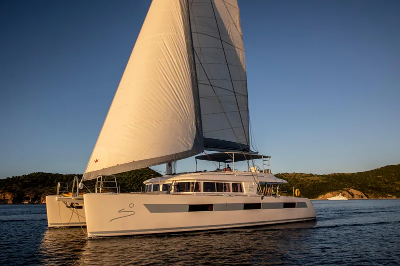Slide: The Image of Lagoon 620 catamaran sailing on calm waters at sunset, 2014 model. - 5