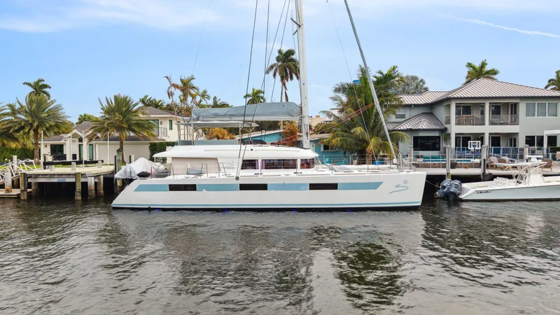 Slide: The Image of Lagoon 620 catamaran docked by waterfront homes, 2014 model. - 9