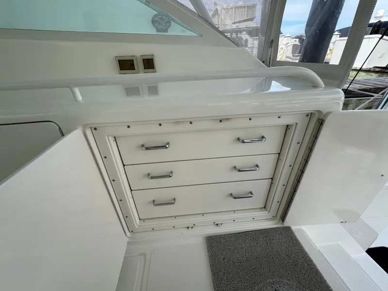 Slide: The Image of 1999 Cabo 45 Express boat interior with storage drawers and white cabinetry. - 17