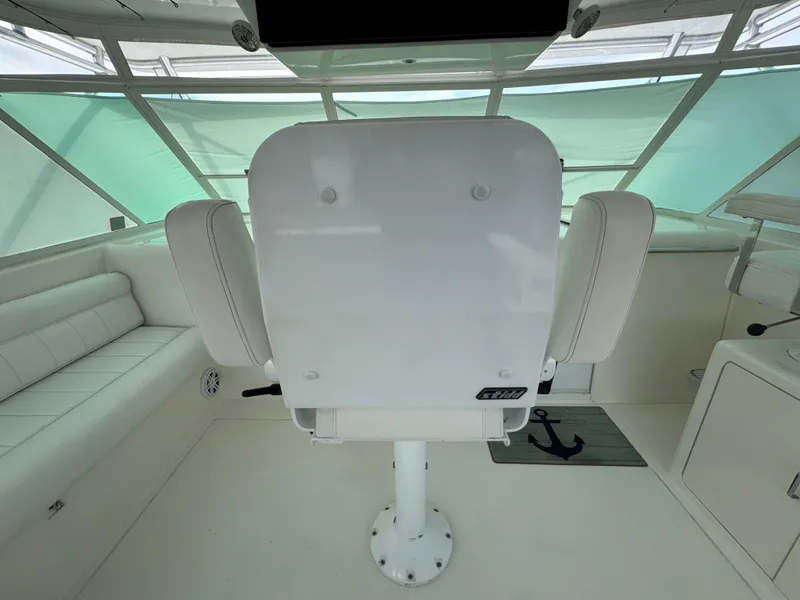 Slide: The Image of 1999 Cabo 45 Express boat interior with captain's chair and seating. - 19