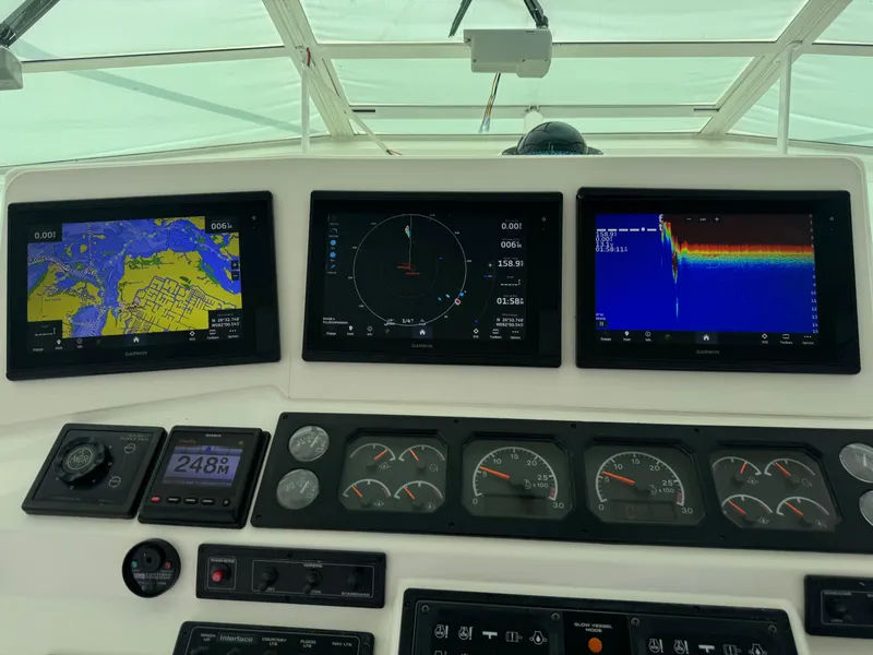 Slide: The Image of Dashboard of a 1999 Cabo 45 Express boat with navigation and sonar displays. - 23