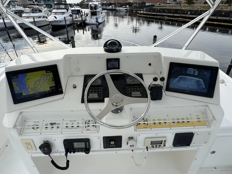 Slide: The Image of Helm of 1999 Cabo 45 Express boat with navigation screens and controls. - 28