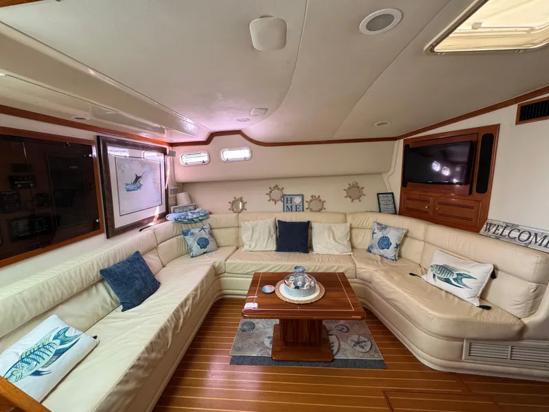 Slide: The Image of Luxurious interior of a 1999 Cabo 45 Express yacht with plush seating and nautical decor. - 35