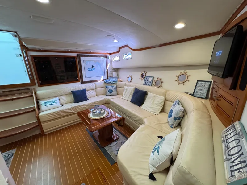Slide: The Image of Luxurious interior of 1999 Cabo 45 Express yacht with plush seating and nautical decor. - 38