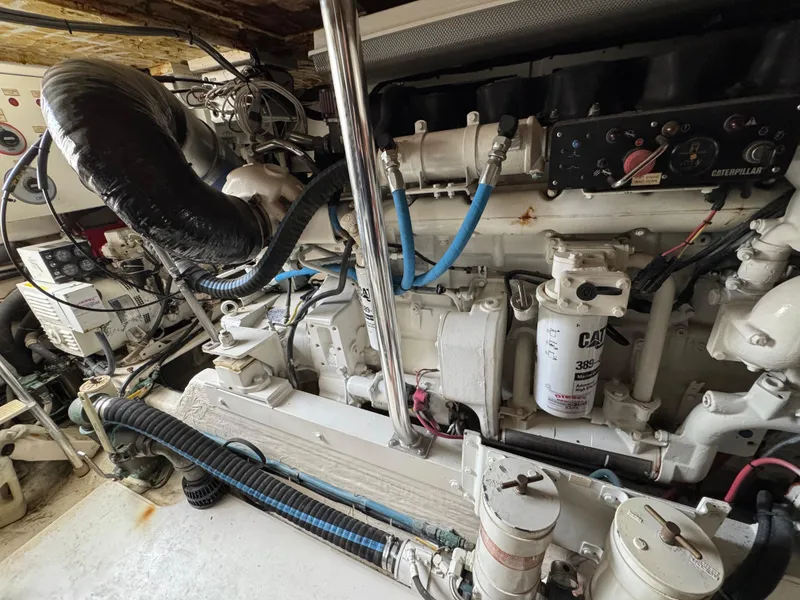 Slide: The Image of Engine room of a 1999 Cabo 45 Express boat, showcasing detailed machinery and components. - 42