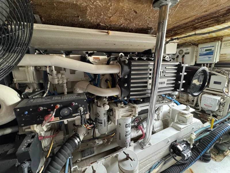 Slide: The Image of Engine room of a 1999 Cabo 45 Express boat, showcasing detailed machinery and components. - 45