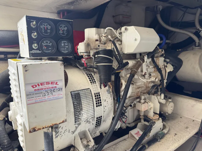 Slide: The Image of Diesel engine in a 1999 Cabo 45 Express boat, featuring control gauges and wiring. - 46