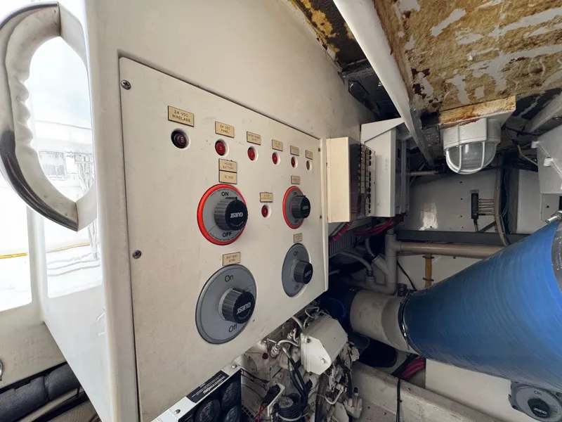 Slide: The Image of Control panel of a 1999 Cabo 45 Express boat engine room. - 48