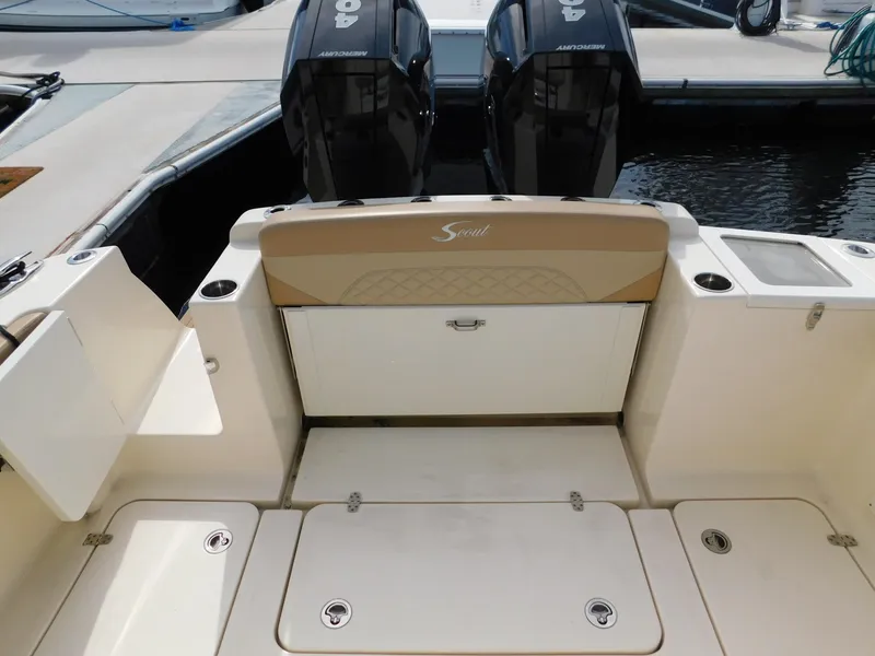 Slide: The Image of 2024 Scout 33LXF boat deck with dual outboard motors at dock. - 10