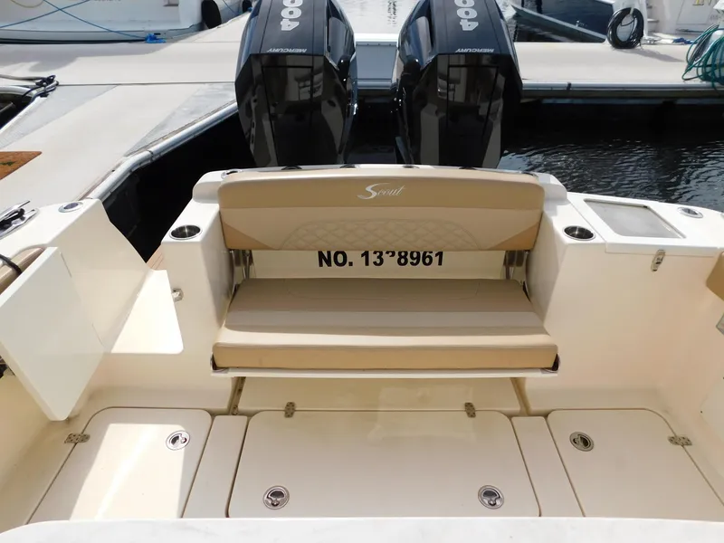 Slide: The Image of 2024 Scout 33LXF boat with twin engines and seating area. - 11
