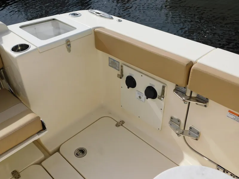 Slide: The Image of 2024 Scout 33LXF boat interior with beige seating and storage compartments. - 12