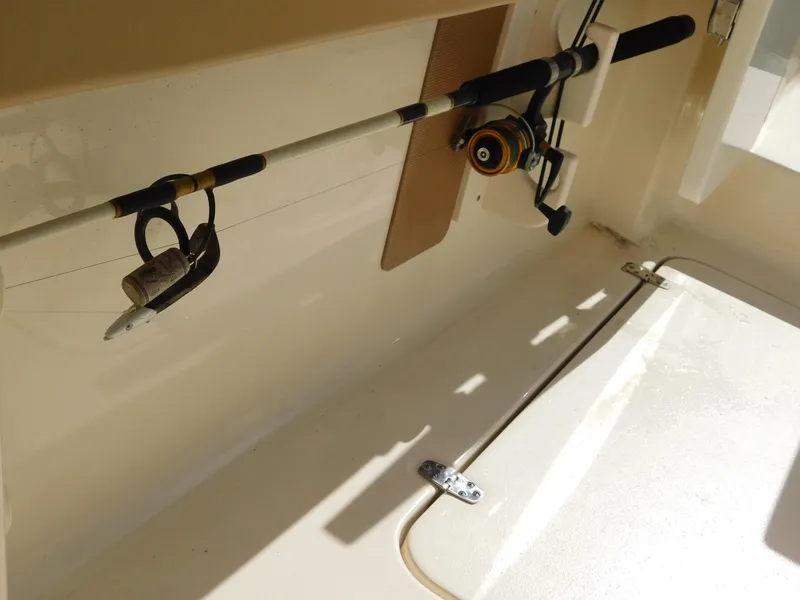 Slide: The Image of 2024 Scout 33LXF fishing rod holder detail in boat interior. - 13